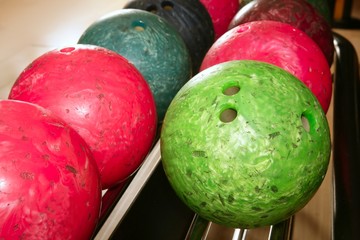 Bowling balls red green closeup row