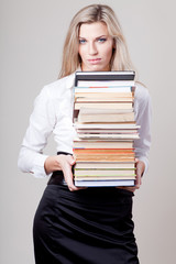 girl holding a stack of books