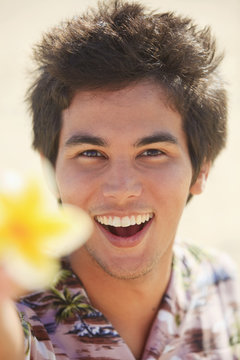 Portrait Of A Pacific Island Man Holding A Plumeria Blossom