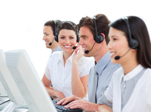 Cheerful business people talking on headset