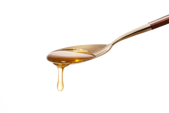 Honey dripping from a spoon