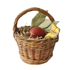 Red dyed eggs and a butterfly in a basket