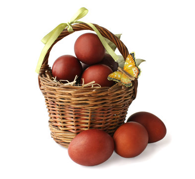 The red colored eggs and a butterfly in a basket