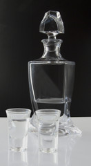 Two little glasses with a crystal bottle