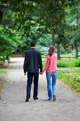 Fototapeta na wymiar Man and woman on a walk in park