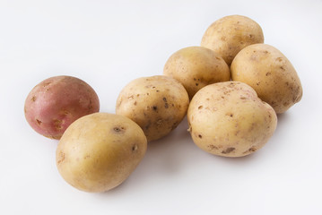 Yellow Potatoes raw and one red colors over white background