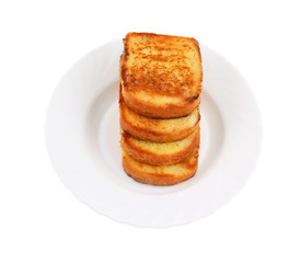 Stack of toasts on white plate isolated