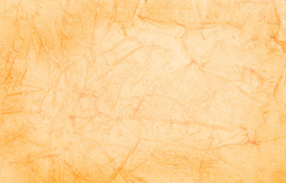 Grungy terracota colored parchment paper background.
