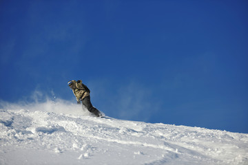 freestyle snowboarder jump and ride