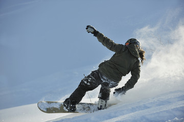 Fototapeta na wymiar freestyle snowboarder jump and ride