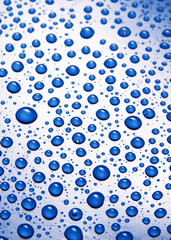 small water drops on blue background macro