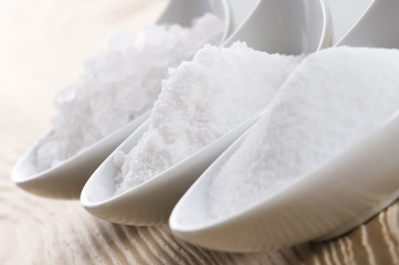 three spoons with difrent salt