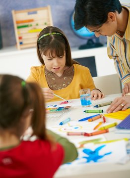 Elementary age schoolgirls painting