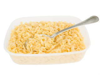 One side curled short-cut pasta with spoon in plastic container.