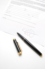 Black pen on a contract with signature