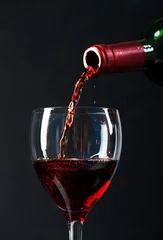 Fotobehang Red wine poured in a glass © Maksim Shebeko