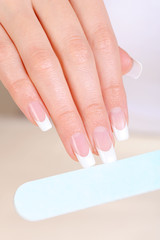 Female  polishing nails on hand with nailfile