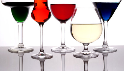 different colored drinks in wineglasses