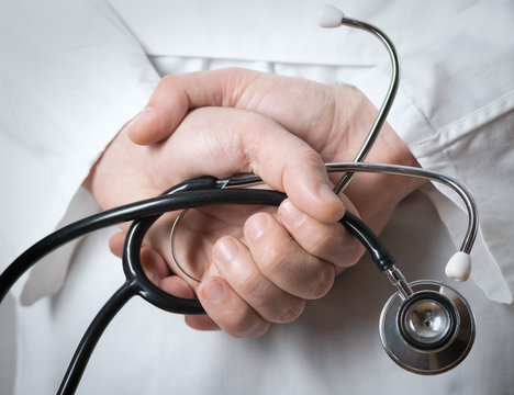 Doctor With A Stethoscope In The Hands Behind The Back