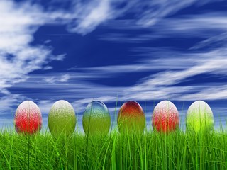 High resolution Easter eggs in grass over a blue sky