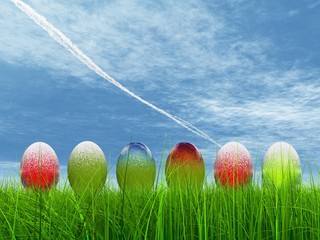 High resolution Easter eggs in grass over a blue sky
