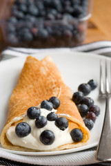 Pancake with fresh blueberries and cream
