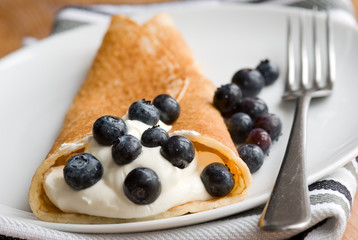 Pancake with fresh blueberries and cream