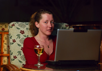 beautiful woman surfing the net in evening outdoor cafe