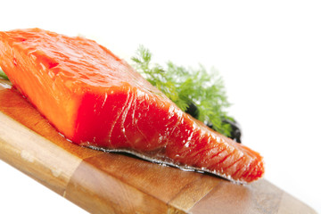 pink salmon on wooden plate with cheese