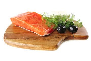 pink smoked salmon on wooden plate with white cheese