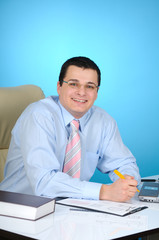 Businessman at work, on blue background