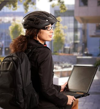 Businesswoman using laptop outdoor