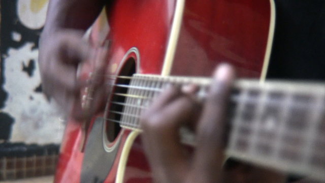 Black man playing the guitar