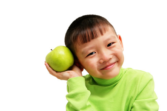 young asian boy with a big green apple