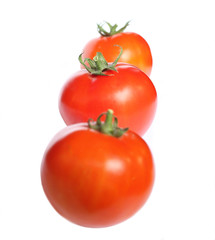 Three red tomatoes in a line