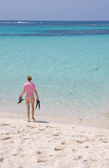 Young female going snorkeling