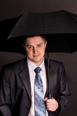 The man in suit with black umbrella