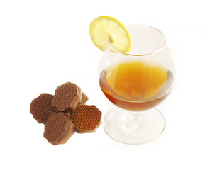 A glass of brandy and chocolates