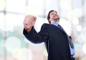 business man standing with fists clenched in victory.