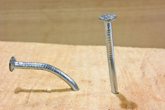Bent Nails on wood plank