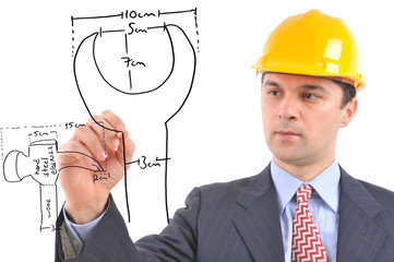An engineer drawing production plans of small tools