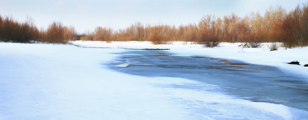 Frozen river. Melt in spring - threat of the flood. Natural disaster