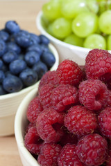 Bowls of Healthy Raspberries Blueberries & Grapes