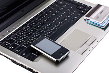 mobile phone with credit cards on laptop