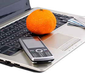 mobile phone with orange on gray laptop