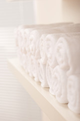 Line of rolled up white bath towels