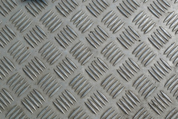 Detail of a grid of steel placed along a road