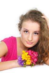 Obraz na płótnie Canvas studio portrait of beautiful girl with flowers