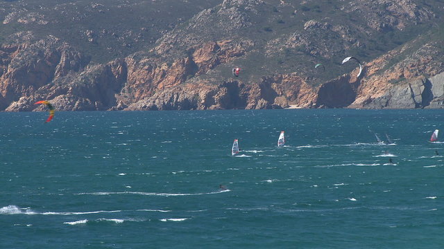 Kitesurfers in action on beach