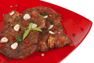 roast beef slices on red dish